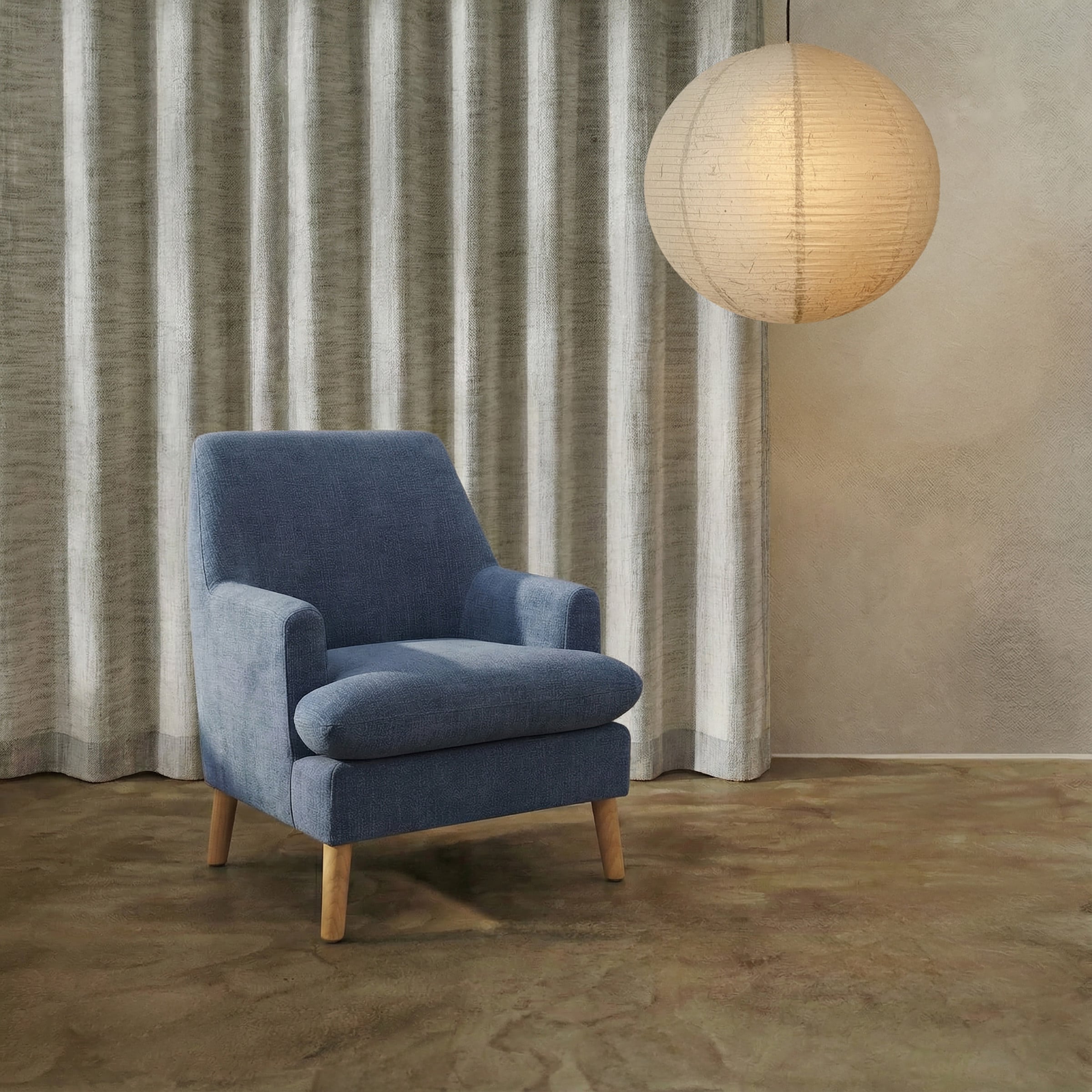 a blue chair in front of a curtain