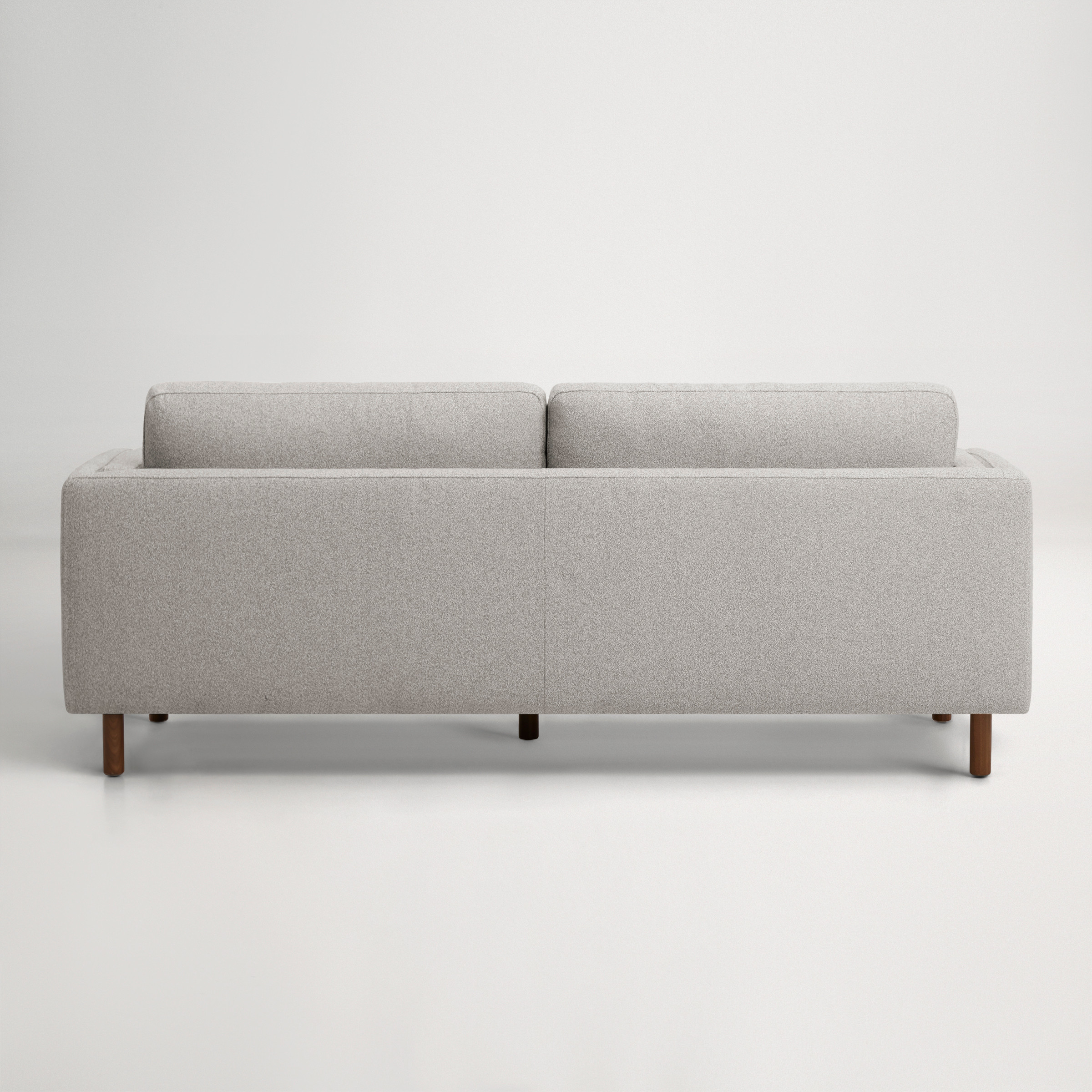 a grey couch with a grey cushion