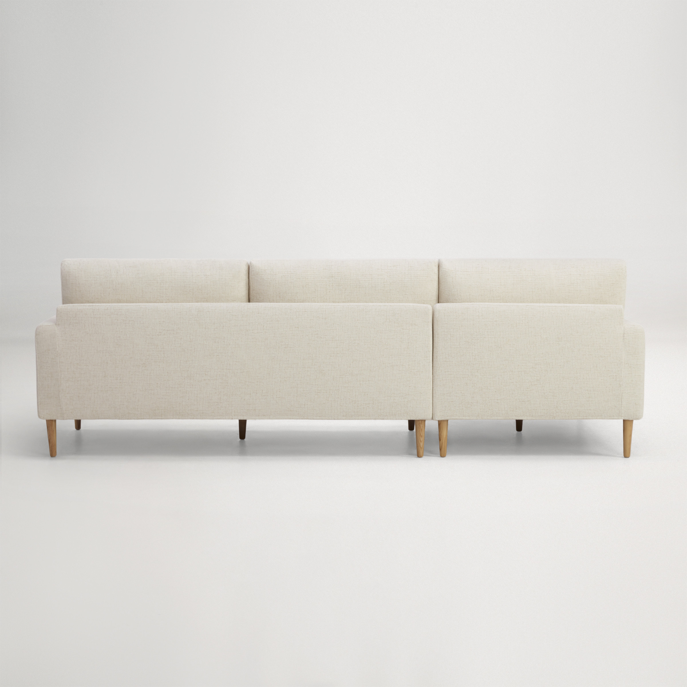 a white couch with a cushion