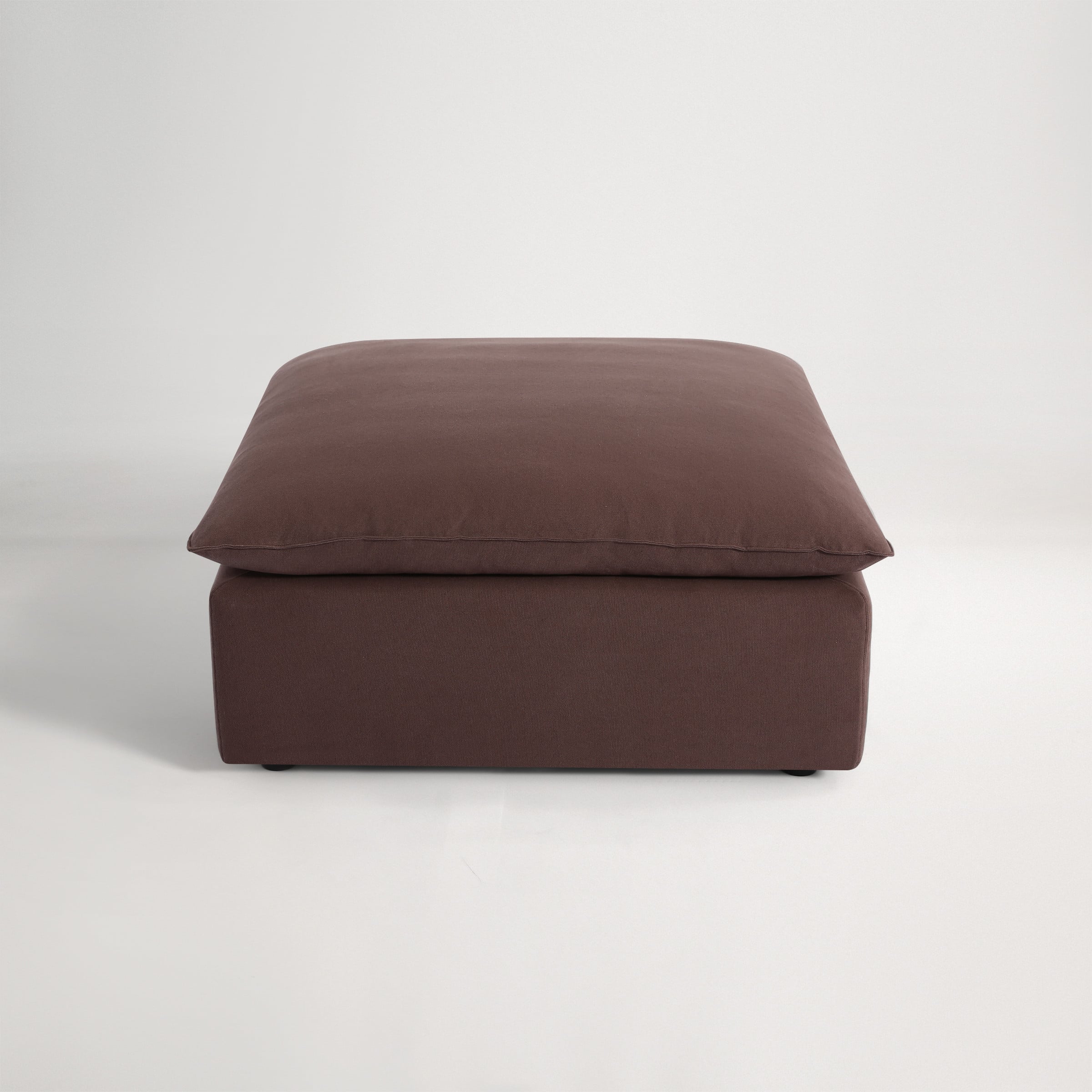 a brown pillow on a white background