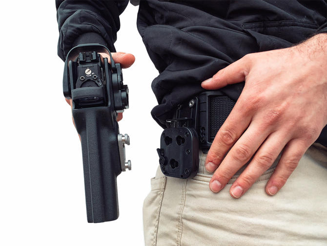 DARA ALQD Receiver Auto Locking Quick Disconnect holster attachment on khaki pants and black shirt.