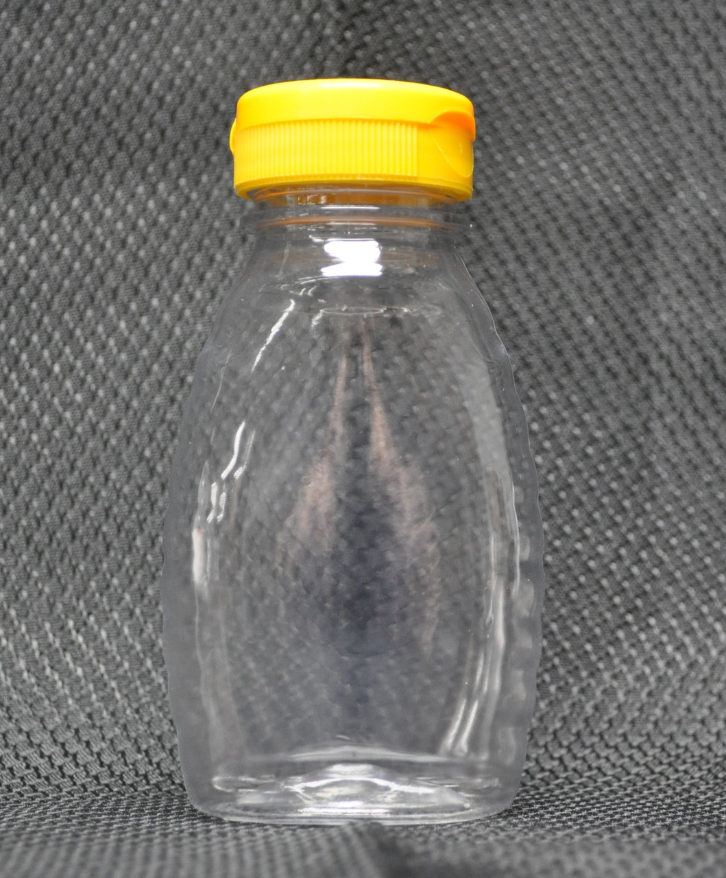 8 oz. clear plastic bottle, with flip-top caps and inner seals