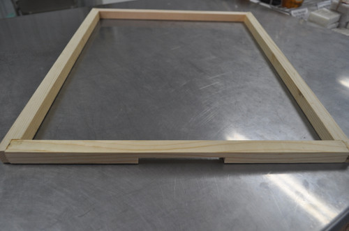 wooden frame for placing on top the beehive to allow bees to go in and out from under the lid