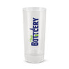 A clear glass shot glass with a printed logo that reads "The Bottlery" in bold letters.