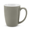 A green ceramic coffee mug with a smooth finish and a white interior, featuring a sturdy handle and subtle branding.