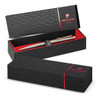 A metal pen in a sleek black and gold design, resting in an elegant presentation box with a logo.