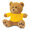 A brown teddy bear plush toy wearing a yellow T-shirt, featuring black button eyes and paw prints on its feet.