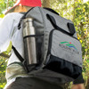 A grey cooler backpack with a drink bottle in the side mesh pocket, featuring a logo on the front.