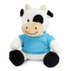 A plush cow toy with a black and white pattern, wearing a blue shirt, seated with a smiling expression.