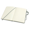A medium-sized Moleskine classic hard cover notebook in green, featuring blank pages and a ribbon bookmark.