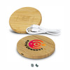 A round wireless charger in bamboo, featuring a logo, accompanied by a charging cable.