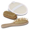 A travel set featuring a wooden hairbrush, a smaller wooden brush, and a round massage brush with a strap.