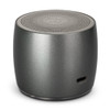 A round, grey speaker with a textured top and a logo, featuring a charging port on the side.