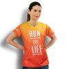 A women's performance V-neck T-shirt in an orange gradient with a logo, featuring a bold slogan on the front.