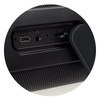 A close-up of a black Bluetooth speaker showcasing USB-C, AUX, and TF card ports. The speaker features a textured surface.