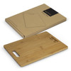 A bamboo chopping board in a rectangular shape, placed near its eco-friendly packaging. The board features a handle.