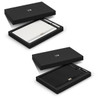 A black gift box containing a white notebook and a pen, both featuring a logo, presented elegantly.