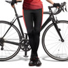 Custom women's cycling pants in black with red side stripes, paired with a bicycle. Features a branding logo.