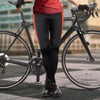 Custom women's cycling pants in black with red detailing, paired with a bicycle. The design features a fitted style.