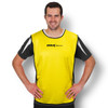 A yellow training bib with black and white accents, featuring a logo, worn by a smiling man.