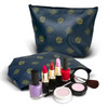 A medium navy cosmetic bag with a logo pattern, accompanied by various lipsticks, nail polishes, and cosmetic brushes.