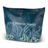 A large cosmetic bag in dark teal featuring floral designs, with a logo and a zippered top for closure.