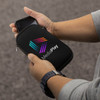 A black phone sleeve with a zip, held in a hand, featuring a multicoloured logo on the front.