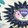 A close-up of a patterned sock featuring a colourful lion design with purple and pink accents.