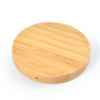 A round bamboo wireless charger featuring a smooth, natural wood finish.