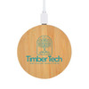 A round bamboo wireless charger in natural wood tones with a logo on the surface. Connected via a white cable.