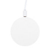 A round, white wireless charger with a textured surface and a connected charging cable.