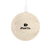 A round, speckled eco-friendly wireless charger in light cream, featuring a logo at the centre and a charging cable attached.