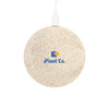 A round, eco-friendly wireless charger in a speckled light colour, featuring a logo on the surface.