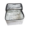 A cooler bag in light grey with a reflective silver interior and a zippered opening. It has a simple design and no visible branding.