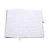An open A5 notebook featuring lined pages and an orange ribbon bookmark, with a black cover.