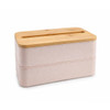 A pink eco lunch box with a bamboo lid features a phone holder slot on top. It has a sleek, stacked design.
