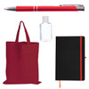 A red tote bag, a silver and red pen, a clear hand sanitizer bottle, and a black notebook with an orange elastic band.