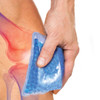 A blue gel bead hot and cold pack is held against a knee, showcasing its flexible design and soothing texture.