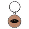 A round keychain featuring a wooden design and a logo on the front, attached to a metal ring.