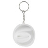 A round keychain with a silver ring and a white silicone straw coiled inside a transparent case.