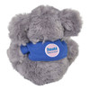 A plush koala toy in grey, wearing a blue shirt with a logo, featuring fluffy fur and rounded ears.