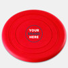 A red silicone frisbee featuring a central logo area and smooth, rounded edges.