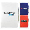 A collection of three notebooks in white, blue, and red, each featuring a logo and a pen attached.
