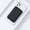 A black magnetic wireless power bank positioned on a white smartphone, featuring a sleek design and logo.