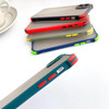 A collection of colourful rugged iPhone cases in various shades, featuring multiple buttons and cut-outs, stacked at an angle.