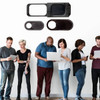A set of three black webcam covers displayed above a group of people using various devices, including laptops and smartphones.