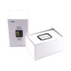 A smart watch in a black and silver design, displayed in an open white box. The box has branding on it.