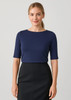 A navy short sleeve women's T-shirt with a round neckline, worn with a black skirt. The shirt features a subtle logo.