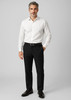 A man stands wearing a white shirt and black wool stretch adjustable waist pants, complemented by black shoes.