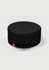 A round, black chef cap with a gathered elastic section and a small branded label.